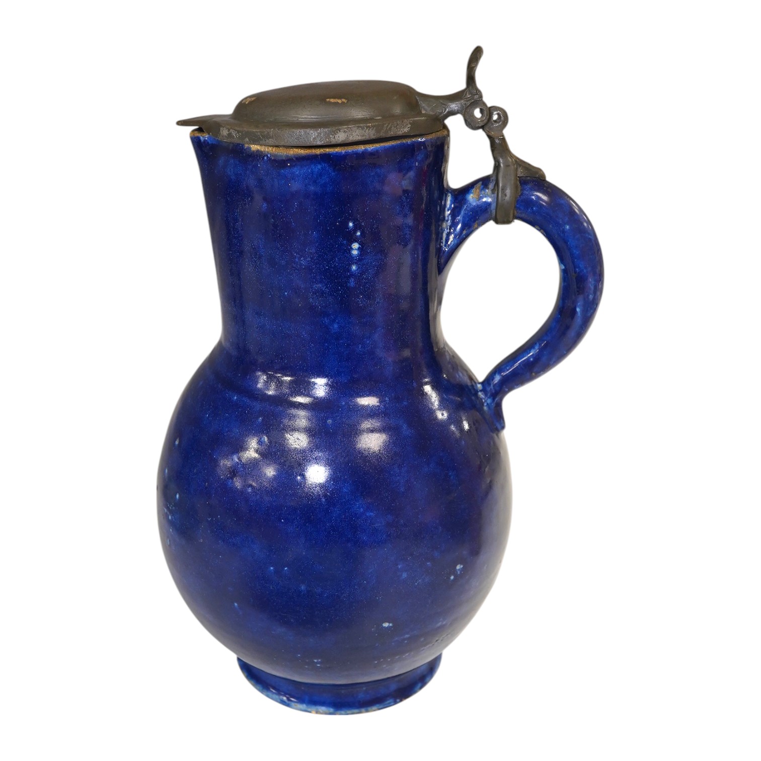 An 18th century German blue glazed faience jug with pewter lid, 30cm. Condition - poor to fair